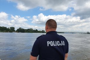 policjant obserwuje poziom wody w Wiśle